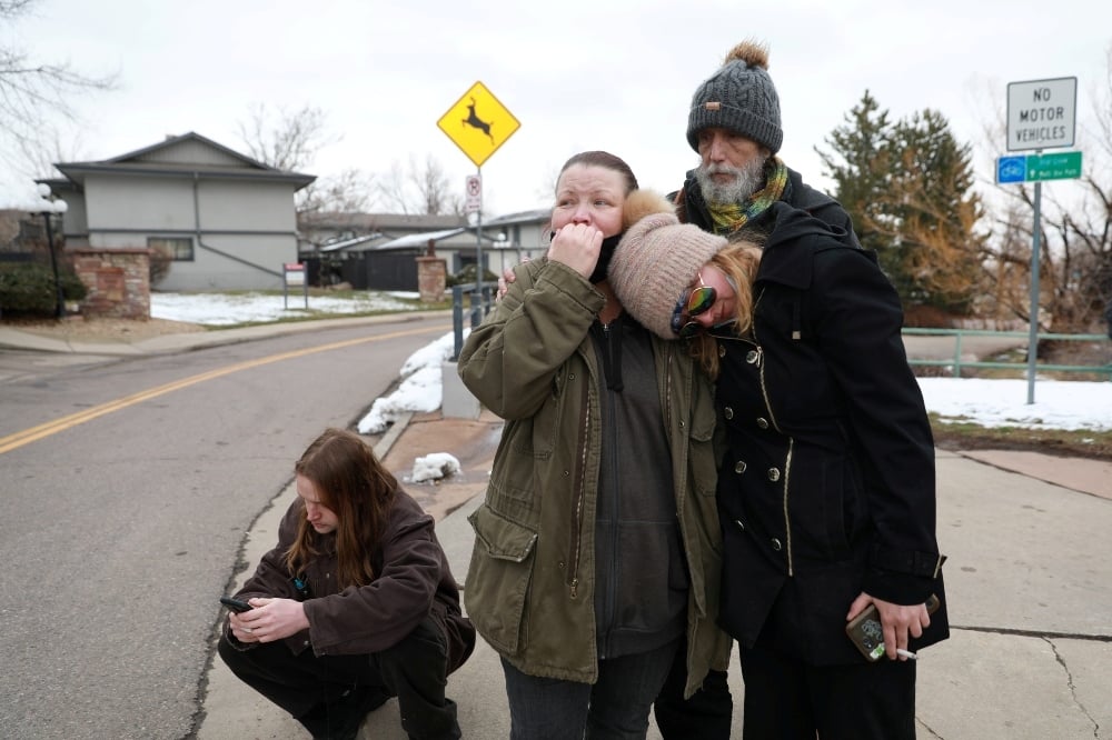 Sarah Moonshadow is comforted by David and Maggie Prowell after Moonshadow was inside King Soopers grocery store during a shooting in Boulder, Colorado, on March 22. &mdash; Reuters