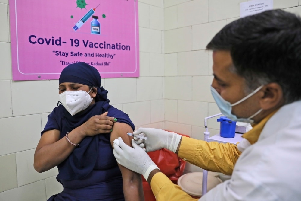A woman receives a Covid- 19 vaccine at a government hospital, in New Delhi, on March 22. — AP