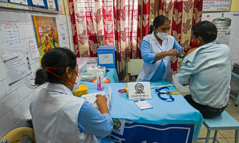 A medical worker inoculates a man with the Covid-19 coronavirus vaccine at a vaccination centre in New Delhi. — AFP
