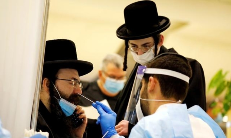 Passengers get tested for Covid-19 after they arrived on a flight to Israel at Ben Gurion international airport near Tel Aviv, in Lod, Israel, March 8. &mdash; Reuters