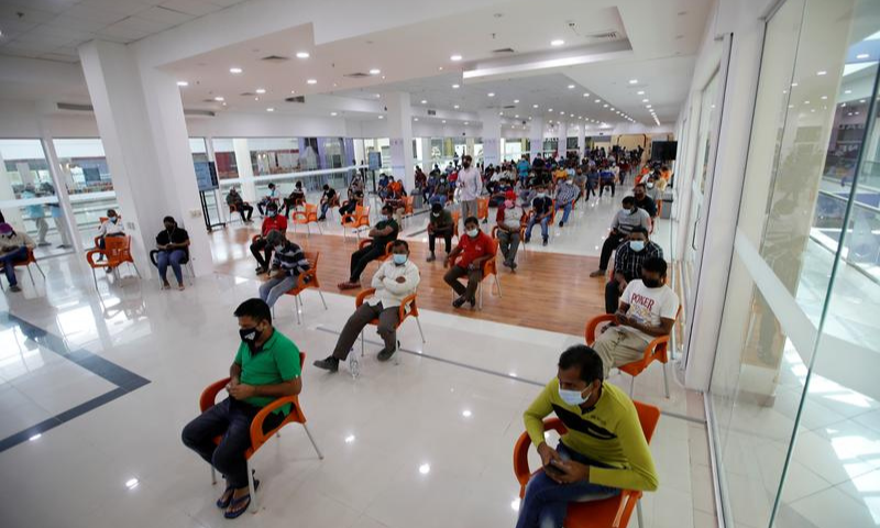 People wait in Sitra Mall to get vaccination against the coronavirus, in Sitra, Bahrain. — Reuters