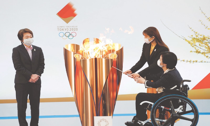 TOKYO 2020 president Seiko Hashimoto looks on actor Satomi Ishihara and Paralympian Aki Taguchi light the celebration cauldron on the first day of the Olympic torch relay in Naraha on Thursday. — Reuters TOKYO 2020 president Seiko Hashimoto looks on actor Satomi Ishihara and Paralympian Aki Taguchi light the celebration cauldron on the first day of the Olympic torch relay in Naraha on Thursday. — Reuters