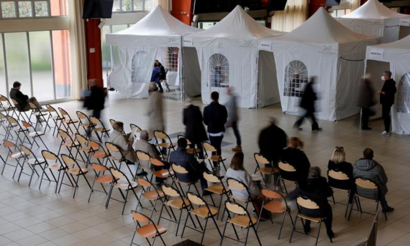 People queue to receive a dose of the Moderna Covid-19 vaccine at a vaccination centre in Marcq-en-Baroeul, France. — Reuters