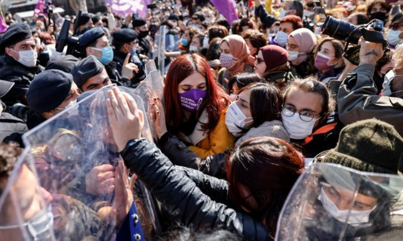 Activists scuffle with riot police as they are stopped in front of a police barricade to prevent them from attending a gathering to protest against Turkey's withdrawal from Istanbul Convention, an international accord designed to protect women, in Istanbul, Turkey on Friday. &mdash; Reuters