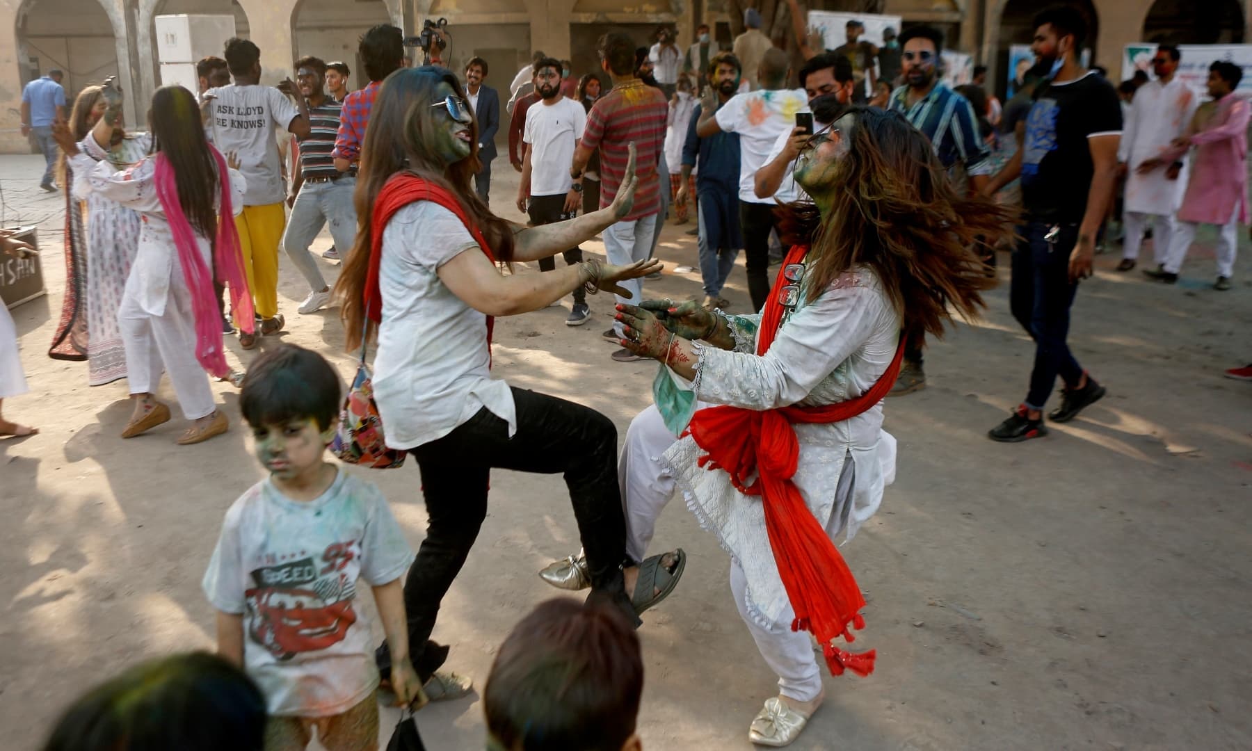 Pakistanis dance to celebrate Holi at a temple in Lahore, Sunday, March 28. — AP