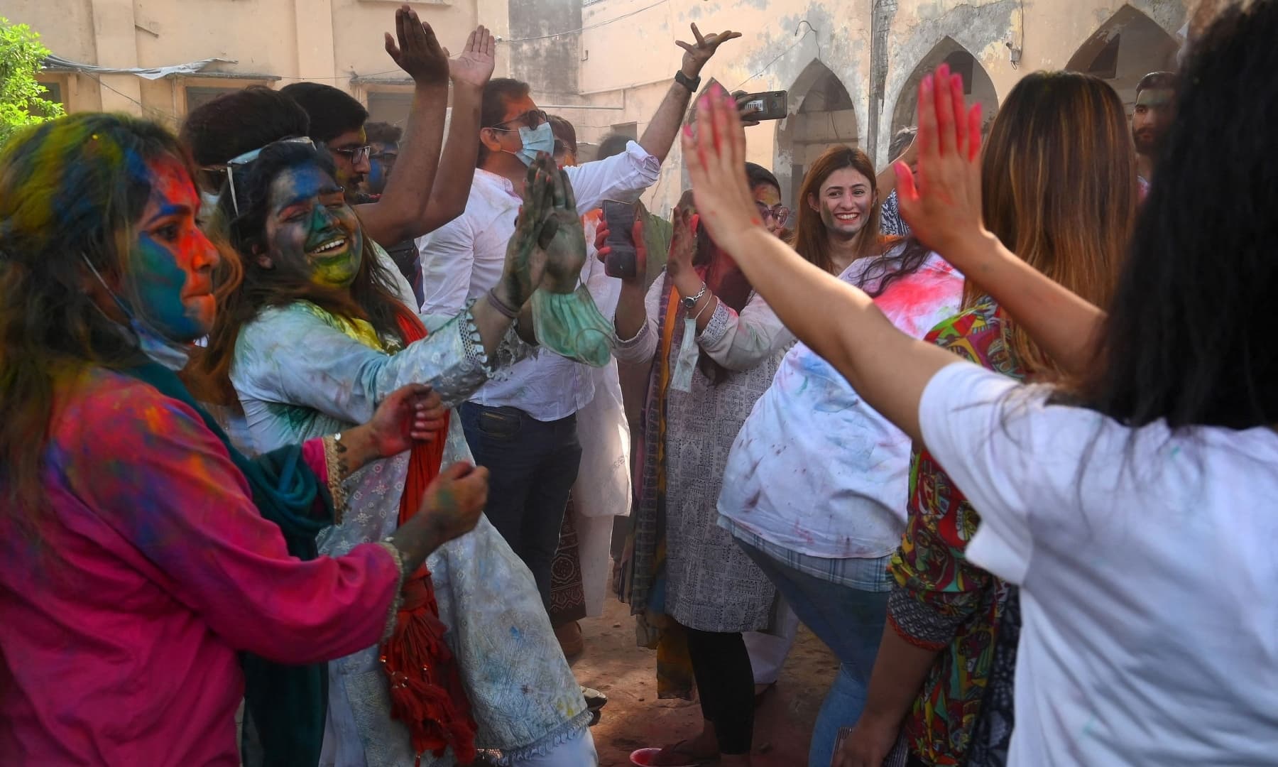 Revellers play with 'Gulal' during Holi celebrations in Lahore on March 28. — AFP