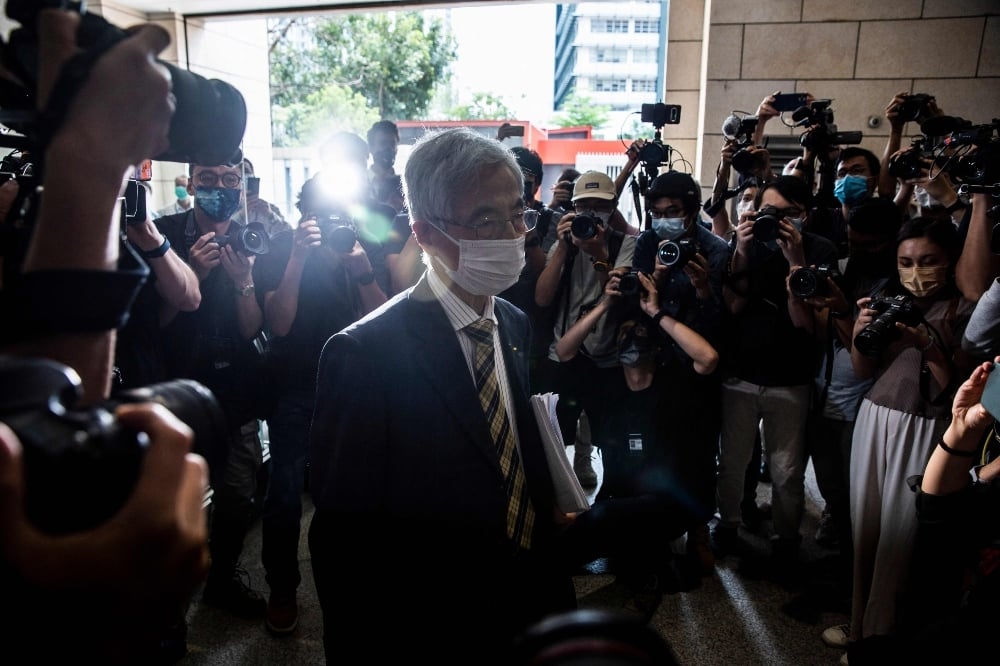 Former lawmaker and barrister Martin Lee (C) leaves West Kowloon court in Hong Kong on April 1. — AFP Former lawmaker and barrister Martin Lee (C) leaves West Kowloon court in Hong Kong on April 1. — AFP