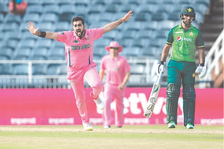 JOHANNESBURG: South Africa’s bowler Tabraiz Shamsi celebrates after dismissing Pakistan’s Shadab Khan (not in the picture), as Fakhar Zaman watches on, during the second one-day match at the Wanderers on Sunday. Pakistan lost the game by 17 runs, but not before opener Fakhar Zaman raised hopes of an unlikely victory by playing a flamboyant knock of 193 runs. The visitors ended up on 324-9 in reply to the Proteas’ formidable 341 for 6. The South African players wore pink outfits to raise awareness about breast cancer.—AP