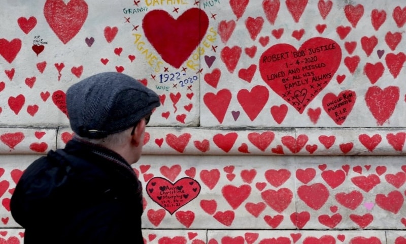 A man walks past the National Covid Memorial Wall commemorating all those who have died of coronavirus, on the Thames Embankment opposite the Houses of Parliament in London, UK, April 8. — AP