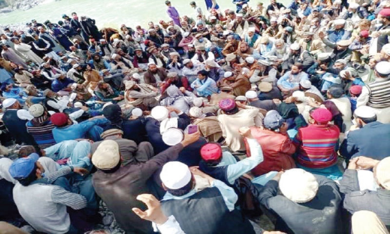 People stage a sit-in on Palas Bridge, the only corridor built on the Indus in Kolai-Palas.&mdash; Dawn