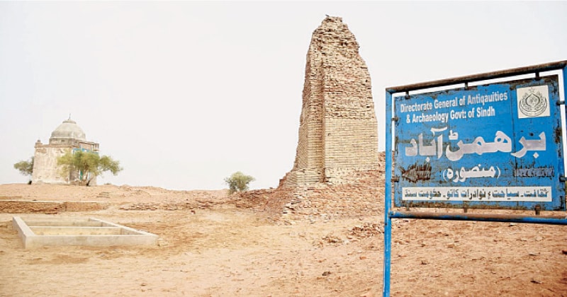 A NAVIGATION watch tower or stupa stands behind a signboard indicating ruins of the ancient site of Brahmanabad and Mansura in Sanghar.—Photo by Umair Ali