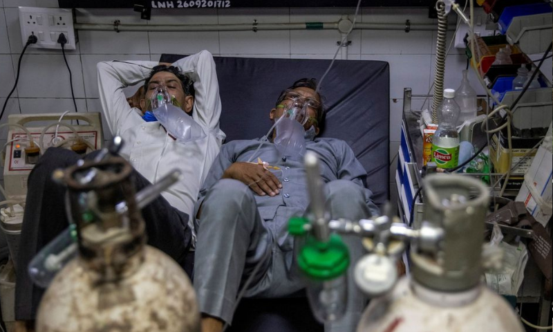 Patients suffering from the coronavirus get treatment at the casualty ward in Lok Nayak Jai Prakash (LNJP) hospital in New Delhi, India. — Reuters