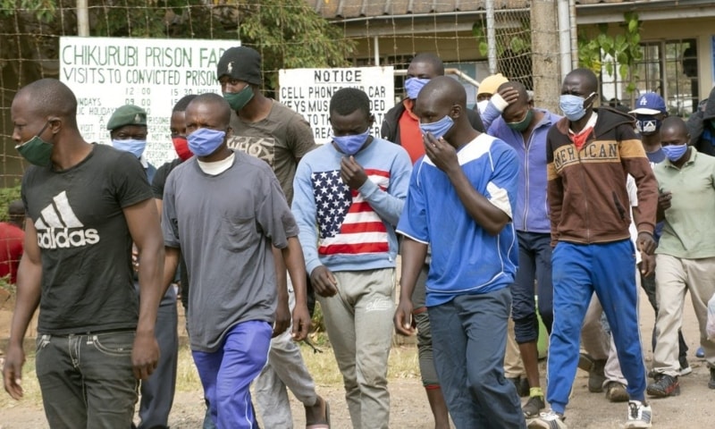 Prisoners walk out of prison following their release at Chikurubi prison on the outskirts of Harare, Zimbabwe, April 17. — AP