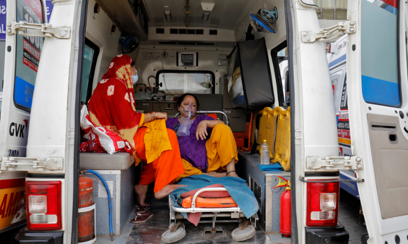 A patient with a breathing problem is seen inside an ambulance waiting to enter a Covid-19 hospital for treatment in Ahmedabad, India. — Reuters