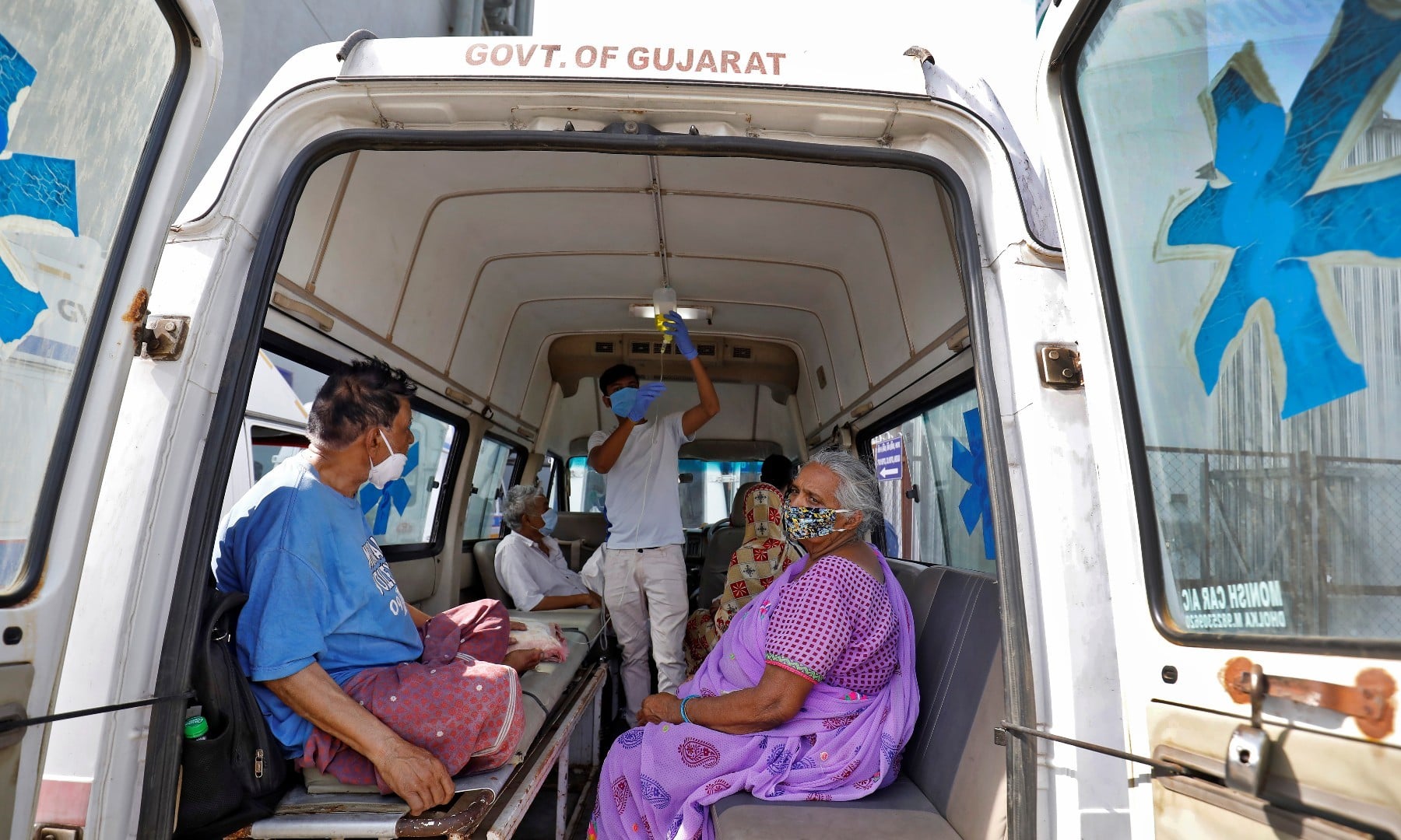 Patients are seen inside an ambulance while waiting to enter a Covid-19 hospital for treatment in Ahmedabad on April 22. &mdash; Reuters