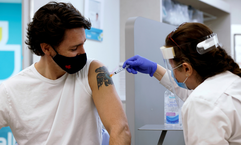 Canada's Prime Minister Justin Trudeau is inoculated with AstraZeneca's vaccine against coronavirus at a pharmacy in Ottawa. — Reuters