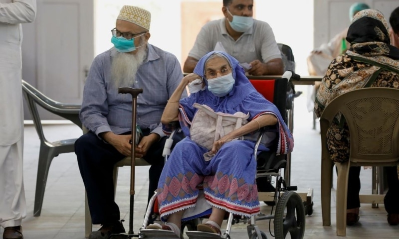 Residents wait for their coronavirus disease vaccine doses, at a vaccination centre in Karachi, April 2. — Reuters