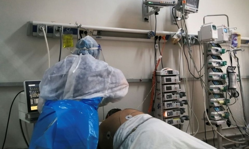 A medical staff member assists a patient suffering from the coronavirus disease at an intensive care department at a hospital in Ariana, Tunisia, April 26. — Reuters