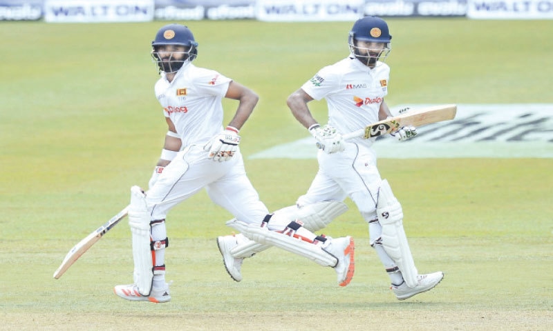 PALLEKELE: Sri Lankan opener Lahiru Thirimanne (L) and captain Dimuth Karunaratne take another  run during their 209-run partnership against Bangladesh at the Pallekele International Cricket Stadium on Thursday.&mdash;AP