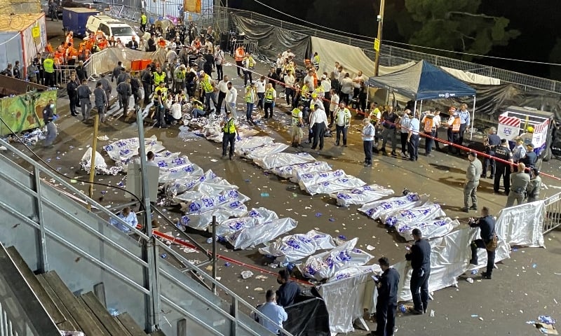Israeli security officials and rescuers stand around the bodies of victims who died during a Lag BaOmer celebrations at Mt Meron in northern Israel on April 30. &mdash; AP