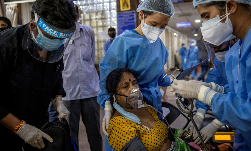 A patient suffering from the coronavirus receives treatment inside the emergency ward at Holy Family hospital in New Delhi, India. — Reuters