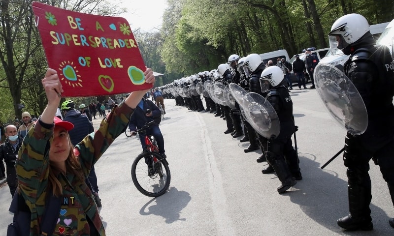 Police officers stand in formation as people gather at the Bois de la Cambre/Ter Kamerenbos park for a party called “La Boum 2” in defiance of Belgium's coronavirus measures on May 1. — Reuters