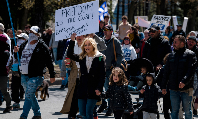 Demonstrators march against new Covid-19 restrictions in Montreal. &mdash; AFP
