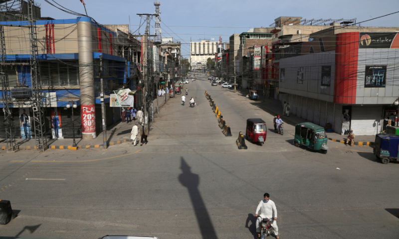 Few people walk through a market area closed due to new government instruction to control the spread of the coronavirus, in Peshawar in this file photo. &mdash; AP