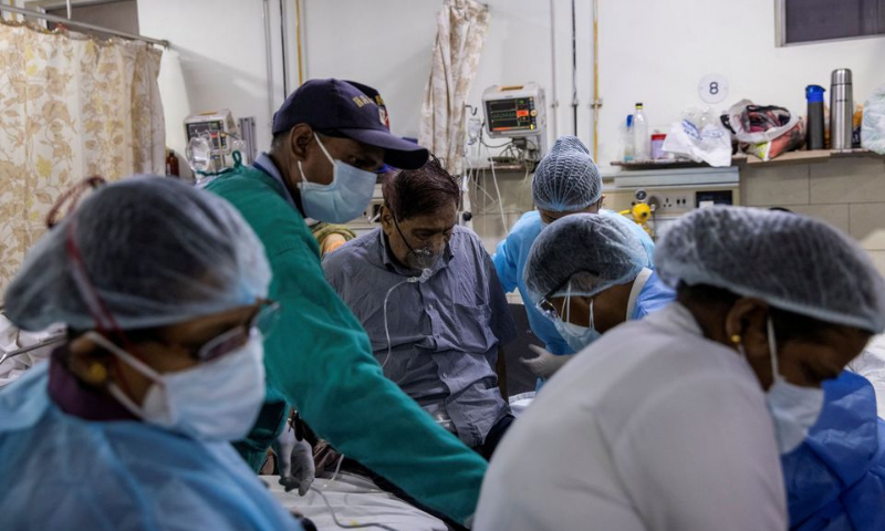 A patient suffering from coronavirus receives treatment inside the casualty ward at a hospital in New Delhi, India. — Reuters