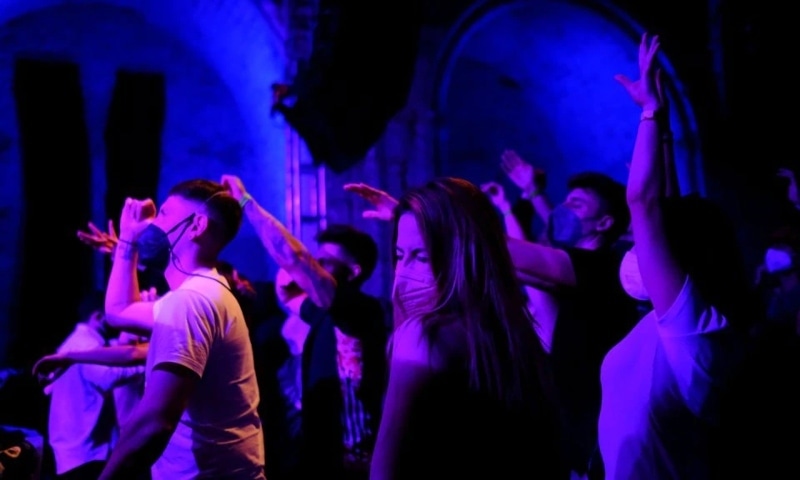 Revellers wearing protective face masks dance inside La Merce cultural centre during Open Girona initiative, Girona, Spain, May 1. &mdash; Reuters