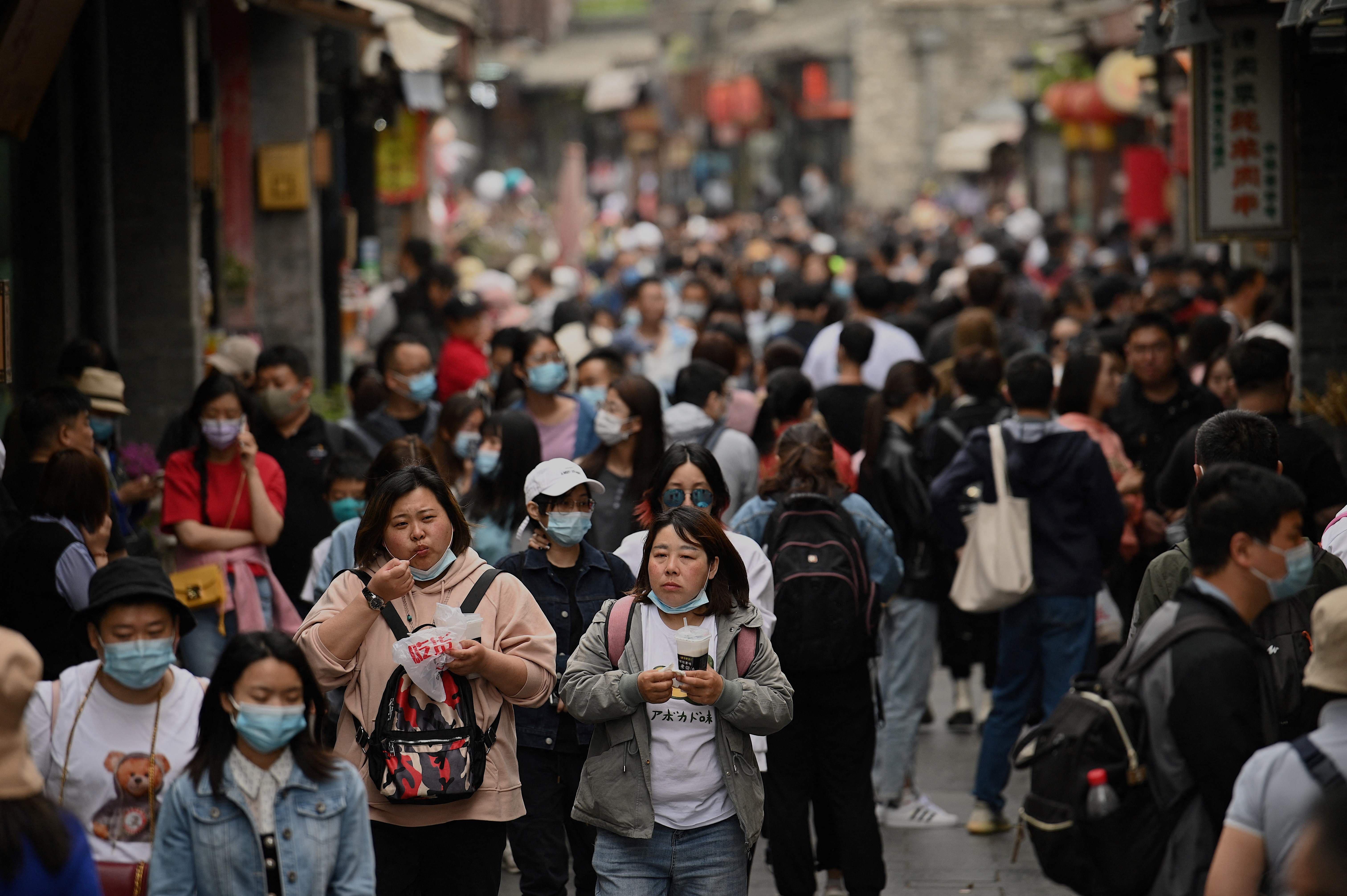 People walk through an alley near Houhai lake in Beijing during the Labour Day holidays on May 4. — AFP