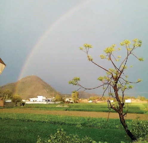 A rainbow appears in the sky on a rainy day in Swabi. — Dawn