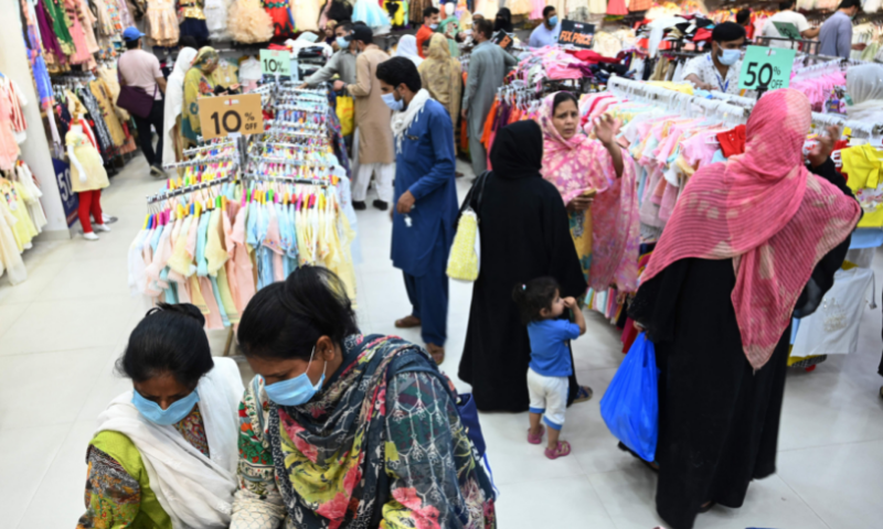 People throng a store during shopping ahead of Eidul Fitr in Rawalpindi on Wednesday. &mdash; AFP