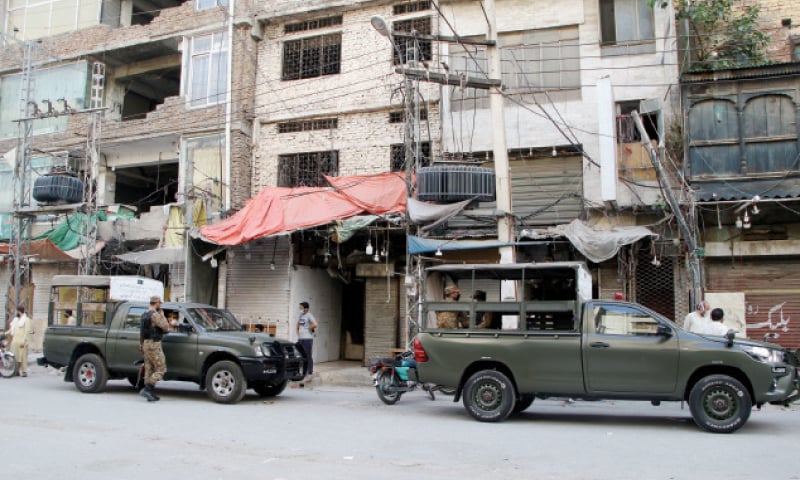 Army personnel seen in their vehicles parked in Rawalpindi’s Bara Market, a policeman arrests a shopkeeper for violating government directives to close shops, Saddar and Islamabad’s Jinnah Super Market give a deserted look on the first day of the nine-day lockdown. — Photos by Tanveer Shahzad & INP