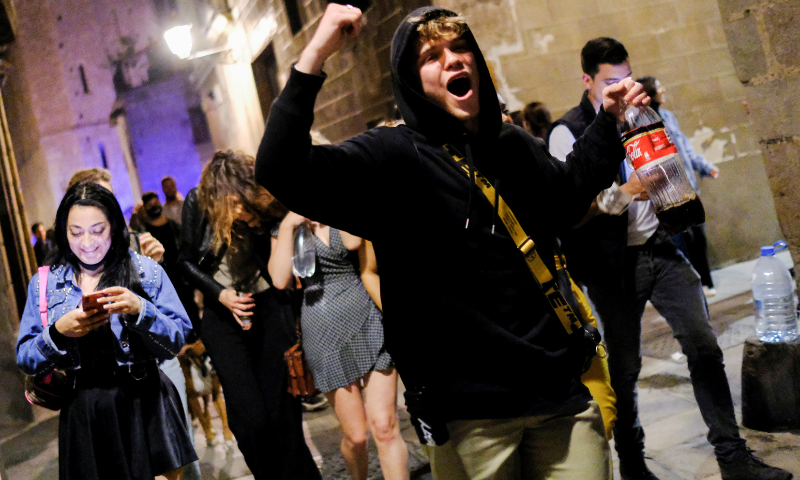 People celebrate on a street in the neighbourhood of Born, as the state of emergency decreed by the Spanish government to prevent the spread of coronavirus gets lifted in Barcelona, Spain on Saturday. &mdash; Reuters