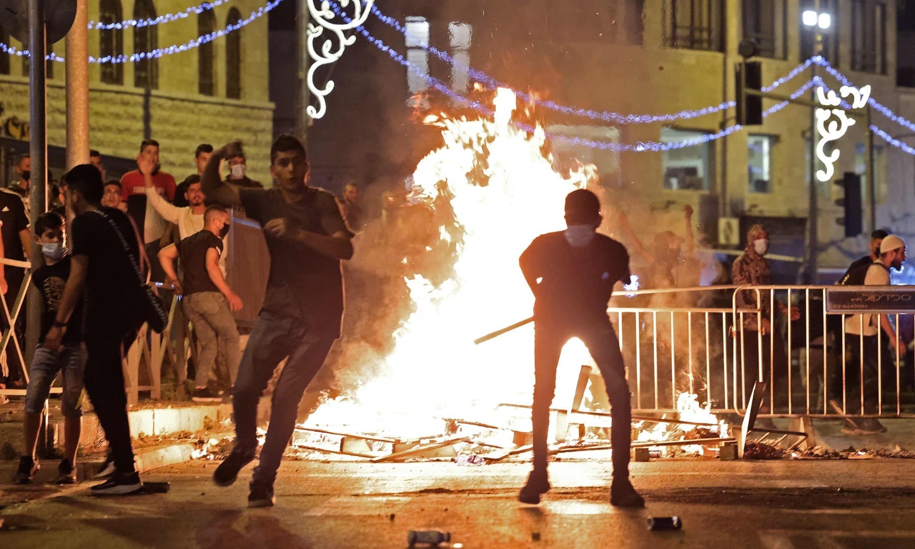 Palestinian protesters hurl stones at Israeli security forces amid clashes in Jerusalem's Old City on May 8. — AFP