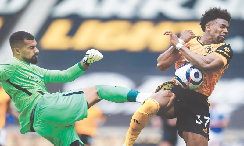 WOLVERHAMPTON: Brighton & Hove Albion goalkeeper Robert Sanchez hits Wolverhampton Wanderers’ Adama Traore during their English Premier League match at Molineux on Sunday.—AP WOLVERHAMPTON: Brighton & Hove Albion goalkeeper Robert Sanchez hits Wolverhampton Wanderers’ Adama Traore during their English Premier League match at Molineux on Sunday.—AP