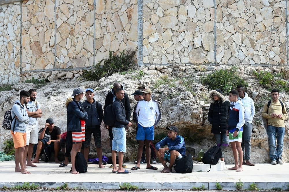 This 2019 file photo shows migrants disembarking from a wooden boat on the island of Lampedusa. — Reuters This 2019 file photo shows migrants disembarking from a wooden boat on the island of Lampedusa. — Reuters