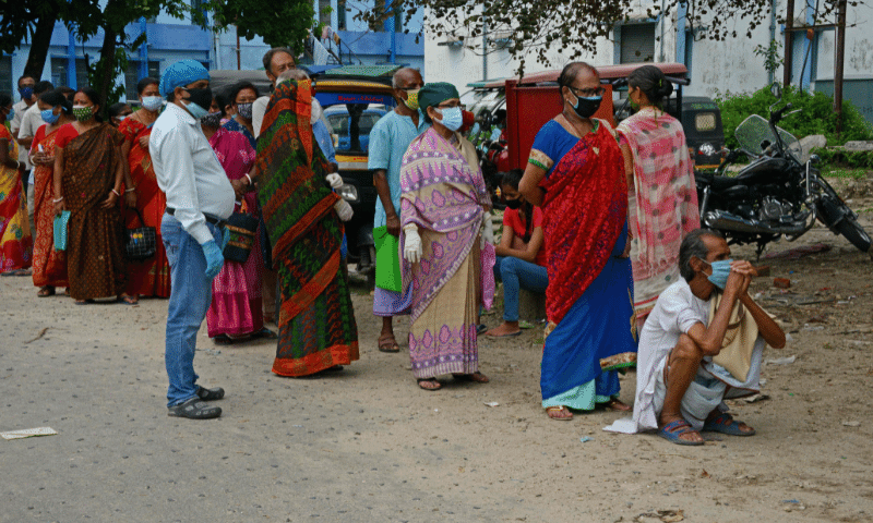 People queue up to get themselves inoculated with the Covid-19 vaccine at the North Bengal Medical College and Hospital on the outskirts of Siliguri, India on Thursday. &mdash; AFP