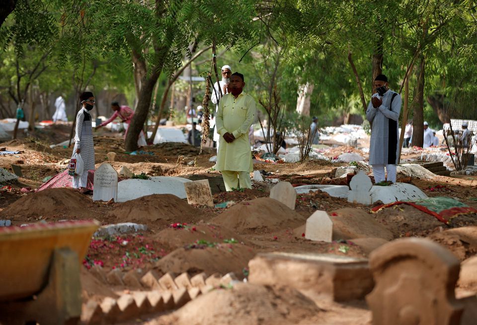 Muslims pray next to the graves of their relatives including those who died from Covid-19 on the occasion of Eidul Fitr, Ahmedabad, India, May 14. &mdash; Reuters