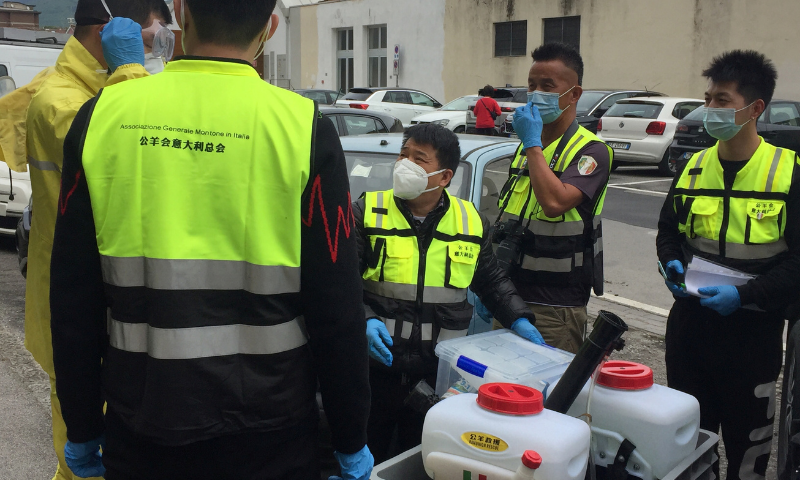 Prato's Chinese community's civil protection unit prepare to disinfect the house of a patient suffering from coronavirus in the Chinese district in Prato, Italy. — Reuters