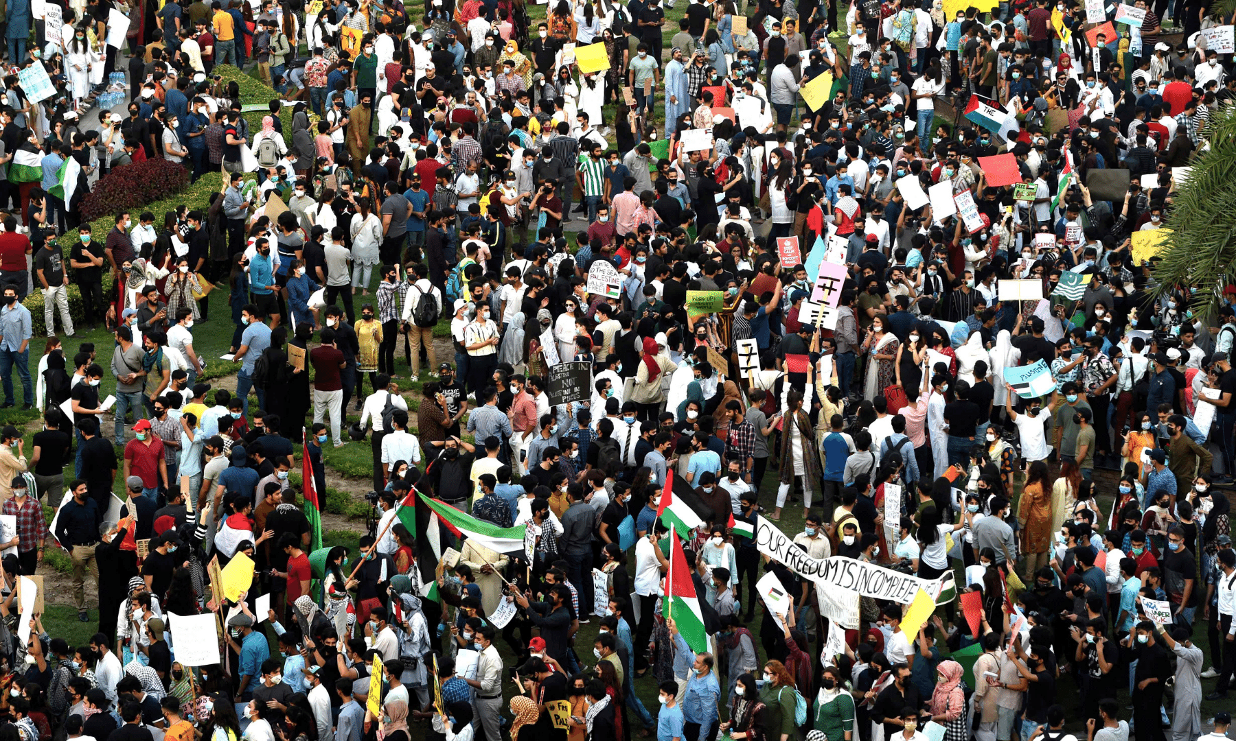 Protesters hold placards as they take part in a demonstration in support of Palestine during an anti-Israel protest rally in Lahore on Monday. — AFP