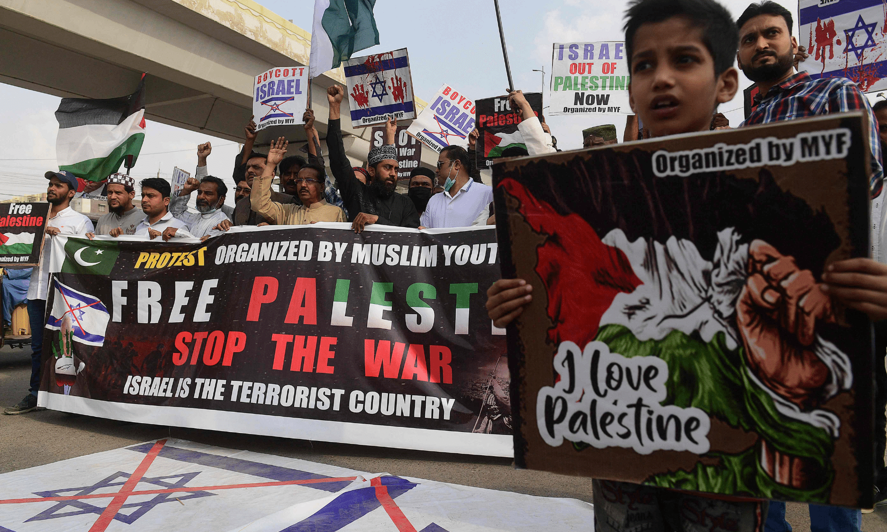 Protesters hold placards as they take part in a demonstration in support of Palestine in Karachi. — AFP