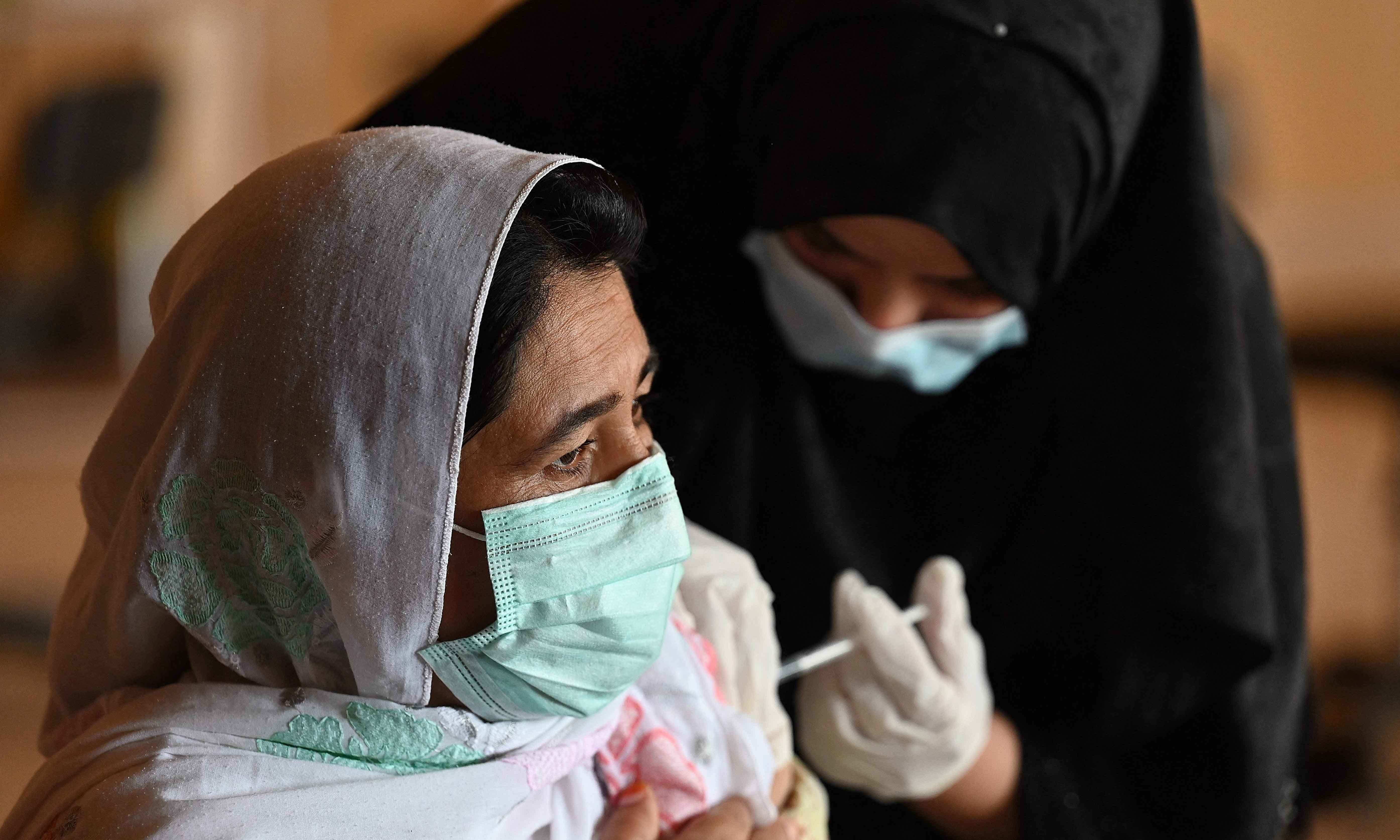 A woman receives the Covid-19 coronavirus Sinovac vaccine at a vaccination camp in Islamabad on May 20. — AFP