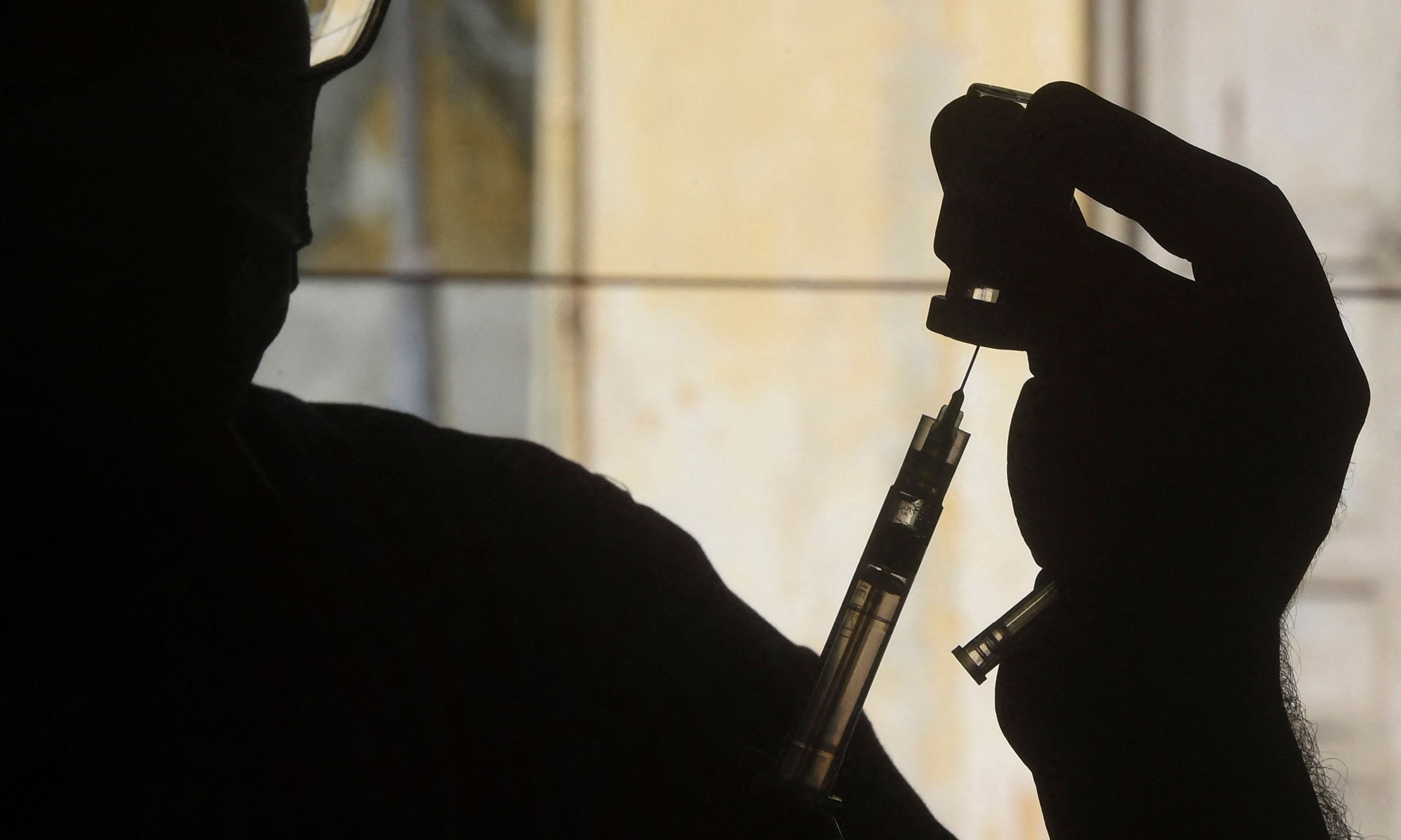 A health worker prepares a dose of the Covishield AstraZeneca-Oxford's Covid-19 coronavirus vaccine at a vaccination centre in Karachi on May 20. &mdash; AFP