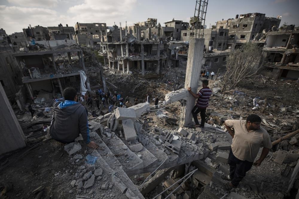 Palestinians inspect their destroyed houses following overnight Israeli airstrikes in town of Beit Hanoun on May 14. — AP