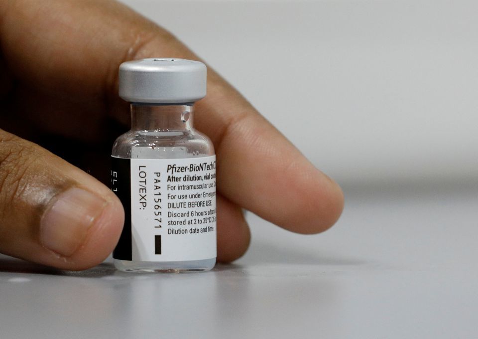 A medical worker prepares to dilute a vial of Pfizer-BioNTech vaccine at a Covid-19 vaccination centre in Singapore, March 8. — Reuters
