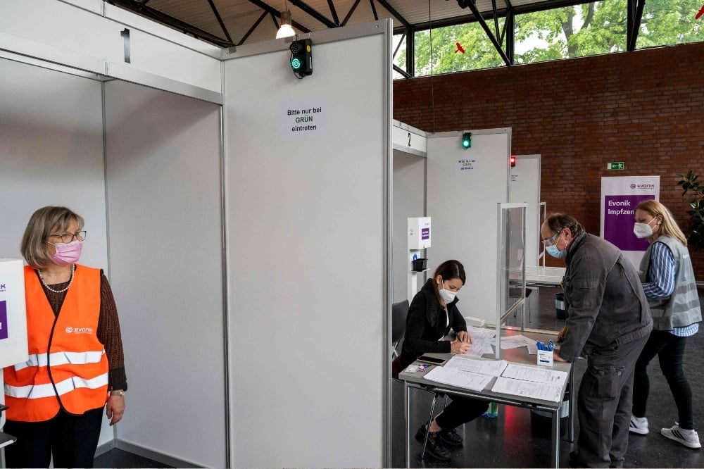 An employee registers before a vaccination with the Pfizer Biontech vaccine at the vaccination center of German speciality chemicals company Evonik in Hanau on May 19. — AFP