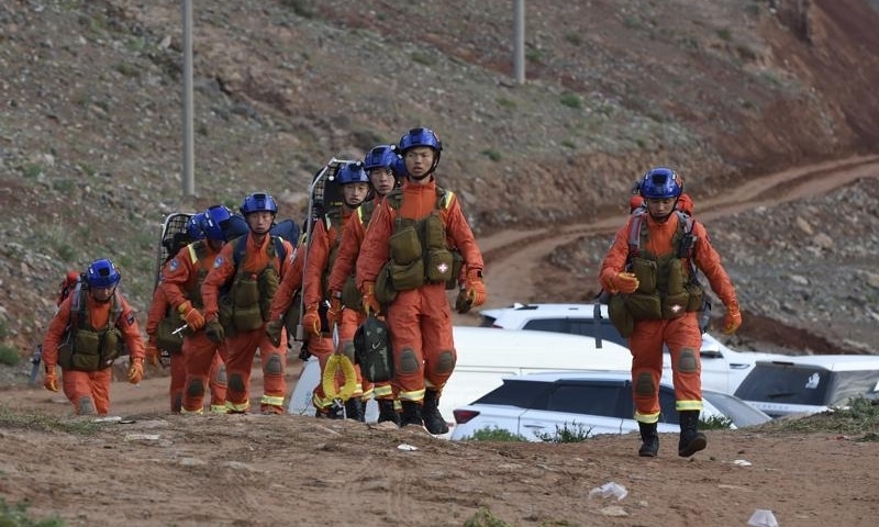 Rescuers walk into the accident site to search for survivors in Jingtai County of Baiyin City, northwest China's Gansu Province, May 23. &mdash; AP