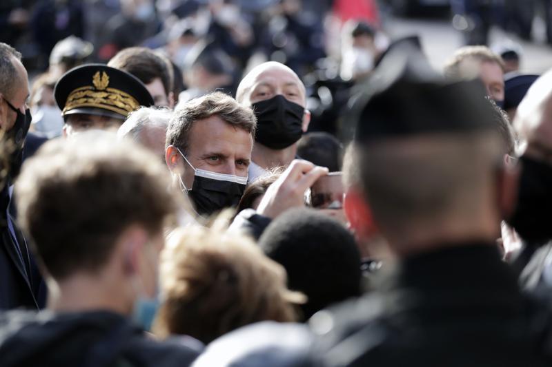 French President Emmanuel Macron speaks with local residents during a visit to mark the reopening of cultural activities after closures during the Covid-19 pandemic, in Nevers, central France, May 21. — AP